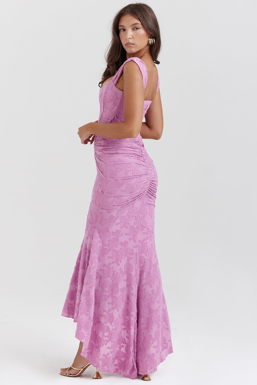 Woman wearing an elegant bodycon dress with soft ruching against a clean background