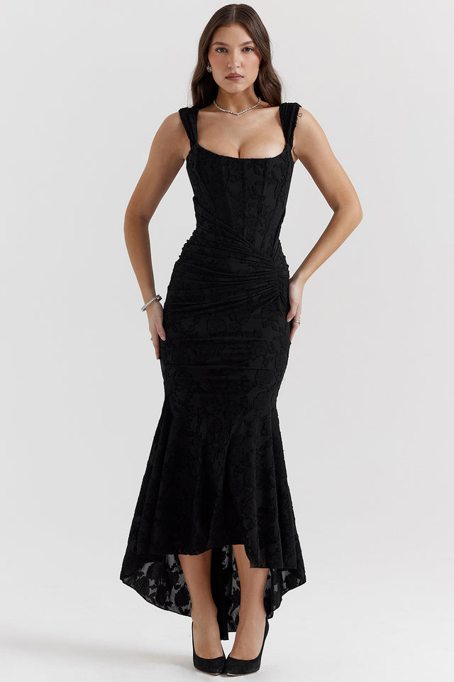 Woman modeling a modern sleeveless dress with a sleek fitted shape on a clean background.