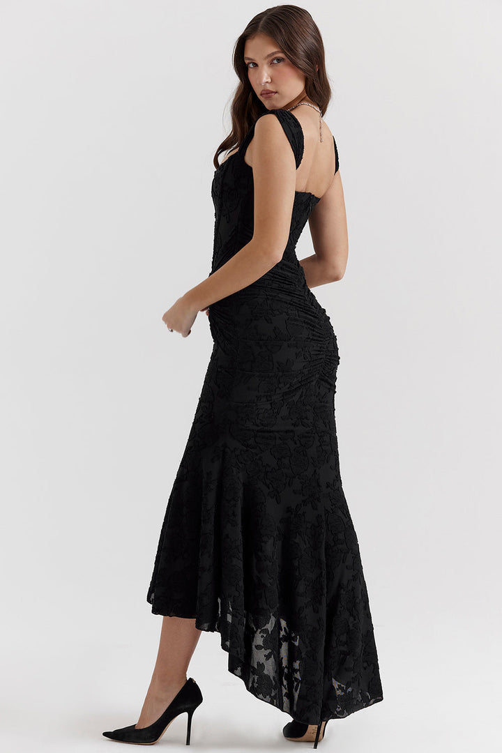 Woman modeling a sleek bodycon evening dress with gathered detailing on a clean background.