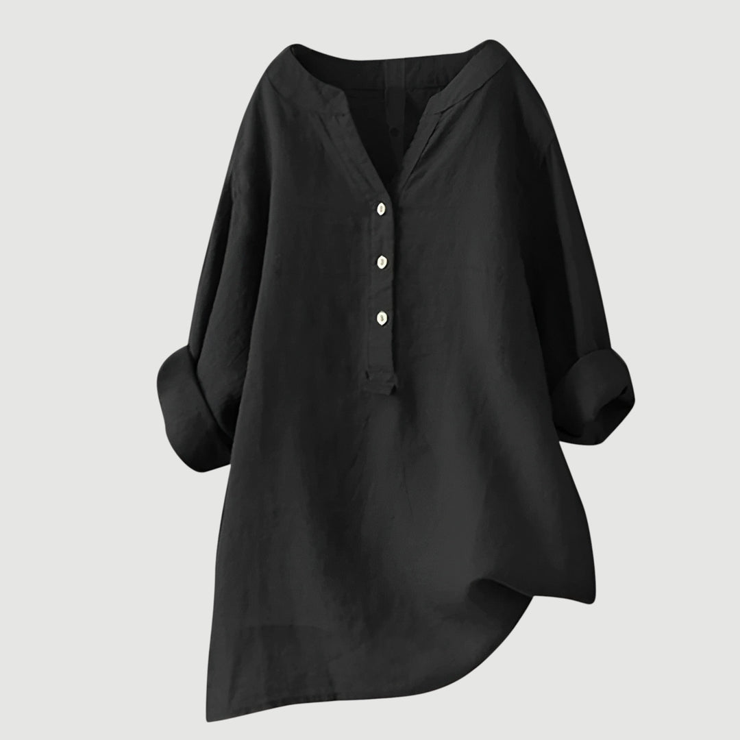 Women’s casual button tunic styled with a clean minimal background.
