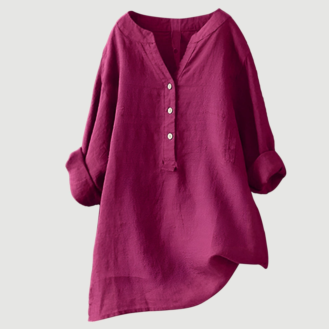 Flowy long tunic top worn by a model on a plain backdrop.