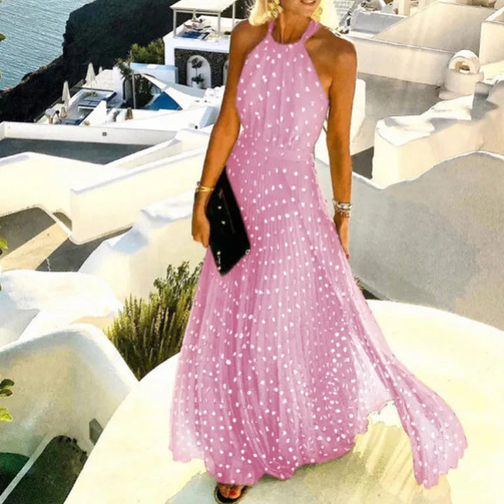 Female model wearing a flowing pleated halter maxi dress