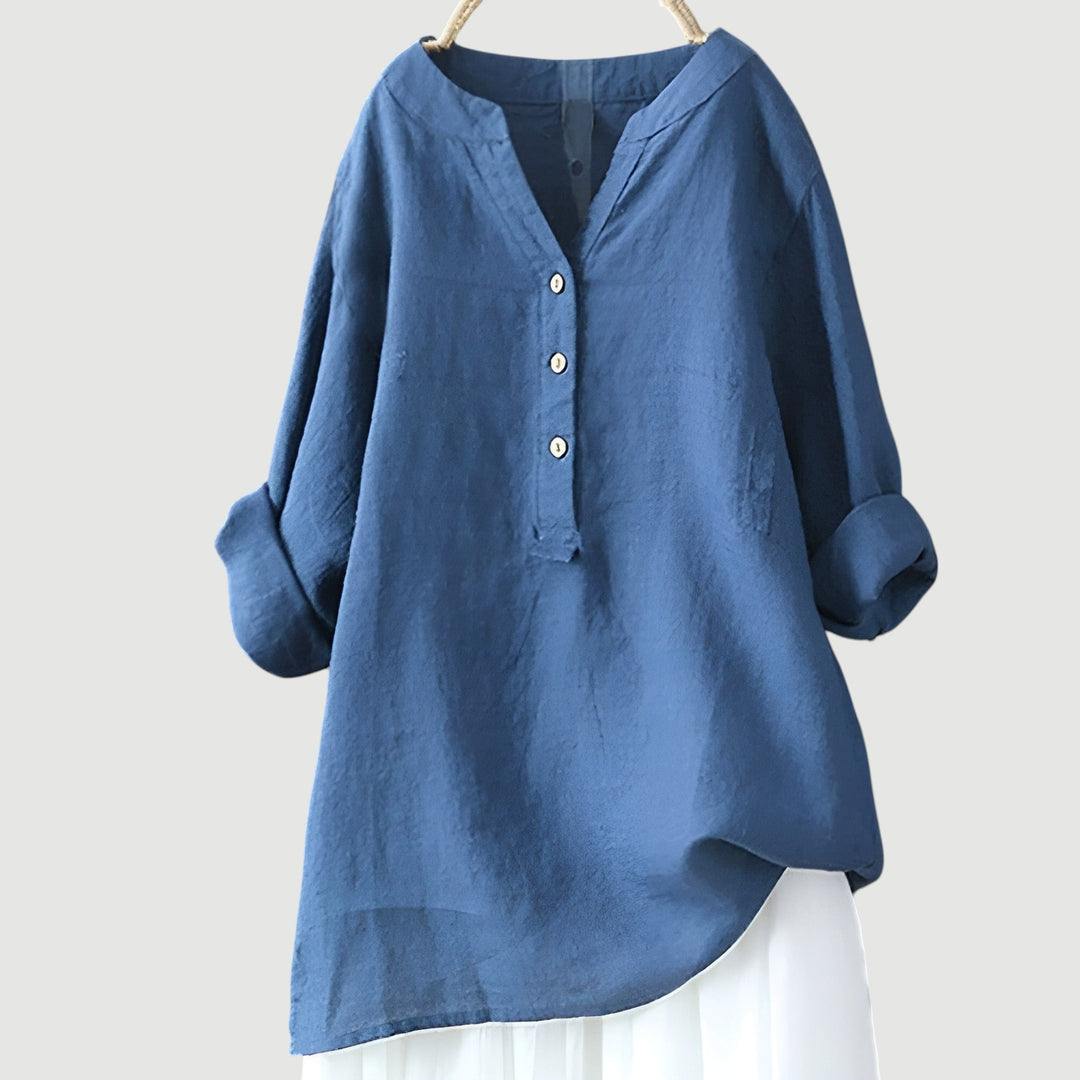 Women’s breathable button tunic displayed on a model with plain backdrop.