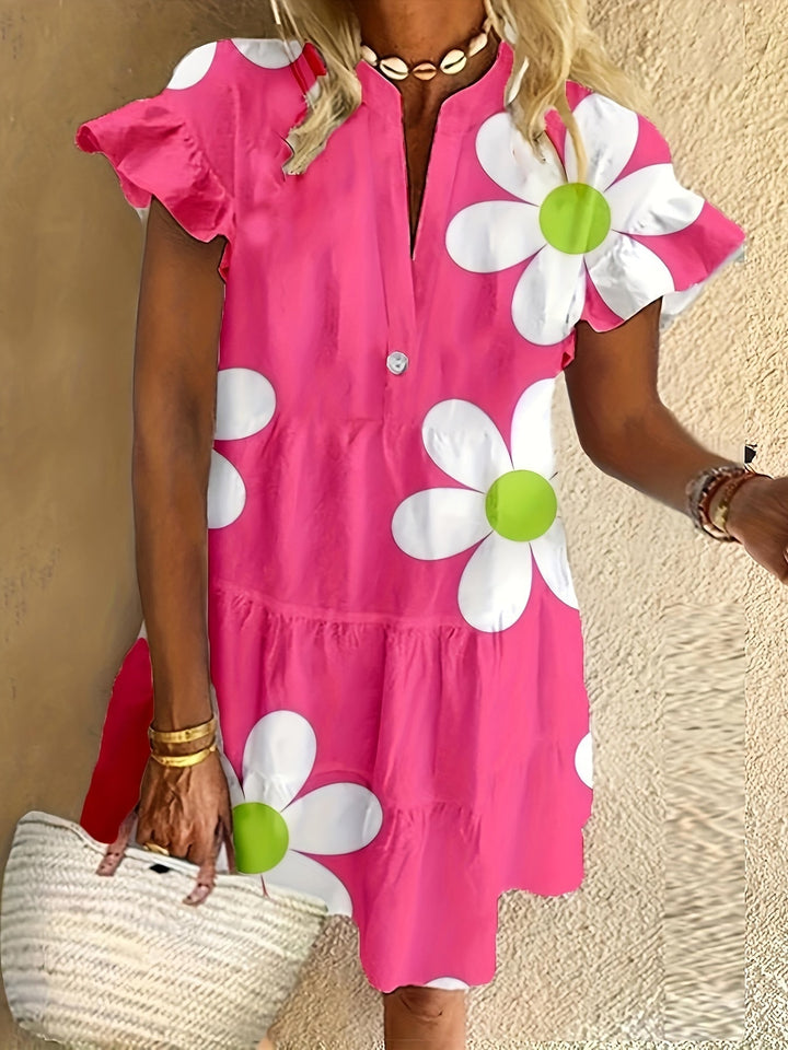 Floral feminine dress with a waist-defining shape and soft blooming pattern.