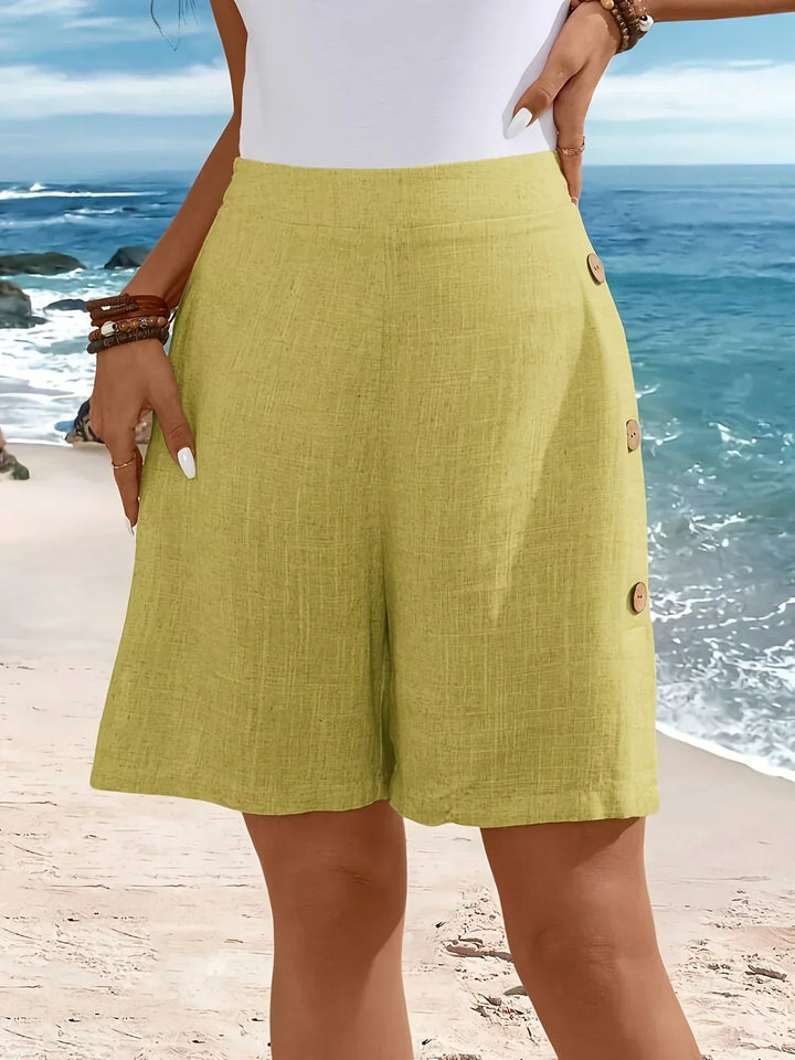 Women’s flattering high-rise shorts with elegant buttons on a female model.