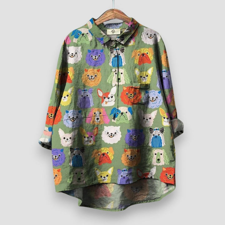 Casual women’s printed blouse with charming dog design on a plain background.