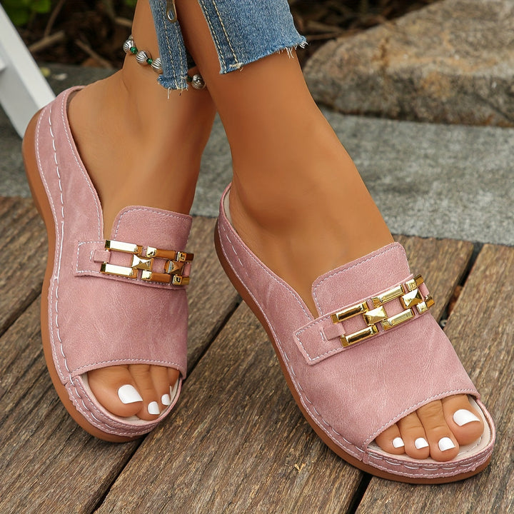 Feet wearing lightweight slide sandals on a clean background emphasizing modern style.