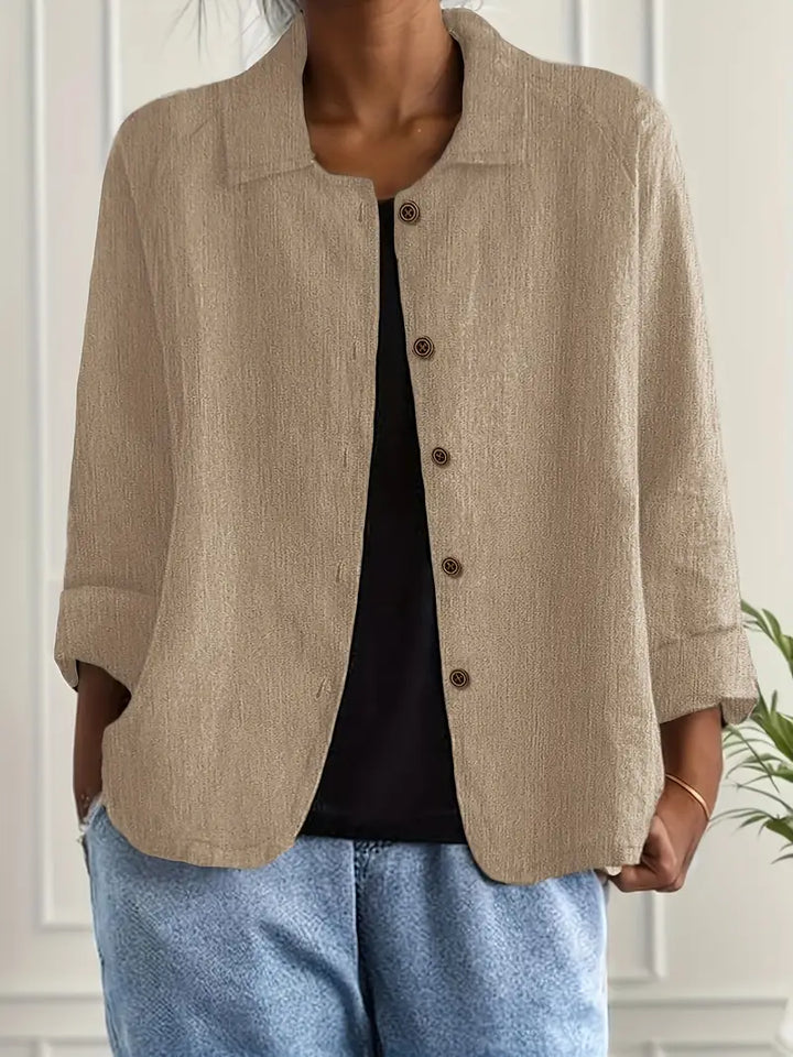 Light classic top shown on a clean background with a refined everyday fashion look.