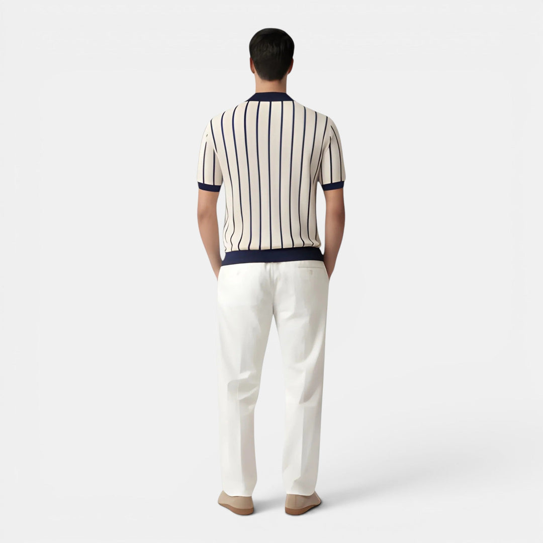  Male model showcasing a striped short sleeve knit top against a plain background.