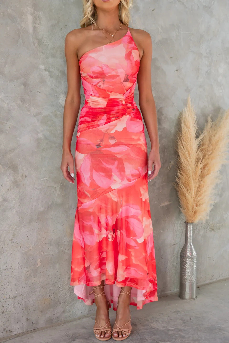 Female model wearing a feminine floral dress on a clean background.