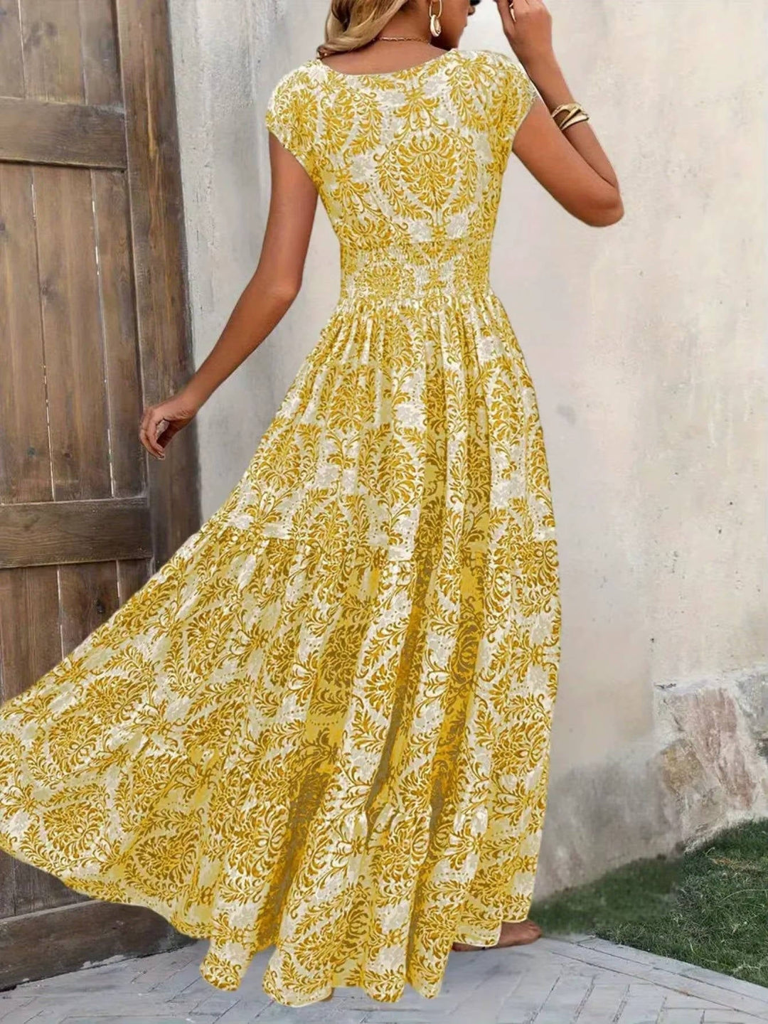 Elegant printed maxi dress worn by a female model in studio lighting