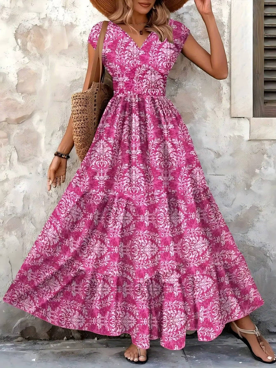 Flowy tiered dress with all-over print displayed on a woman