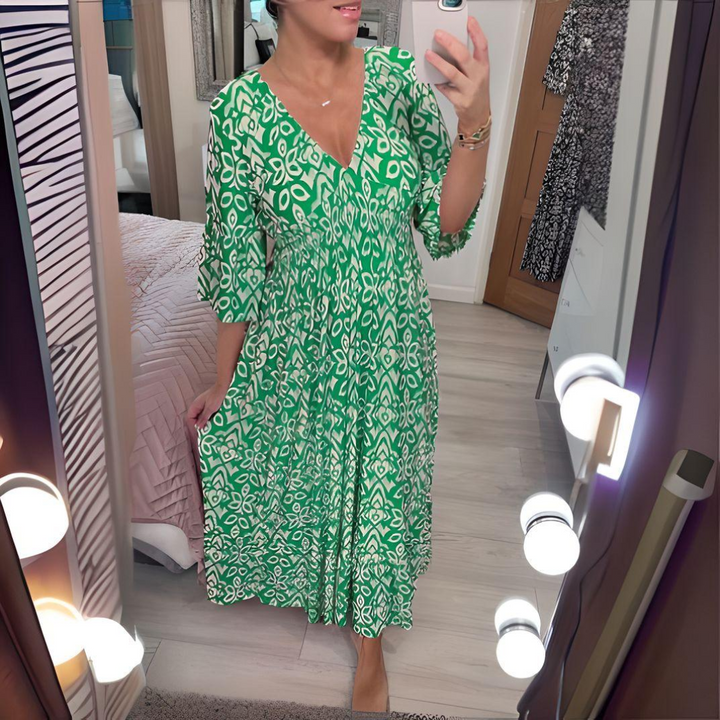Female wearing a relaxed bohemian style dress on a bedroom background.