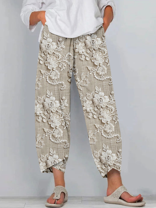 Female model wearing printed wide-leg trousers against a plain background.