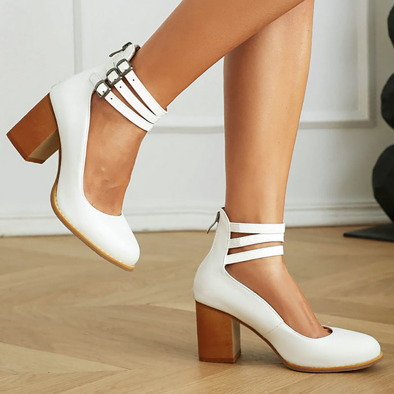 Foot shown wearing a refined low block heel sandal with a secure ankle strap.