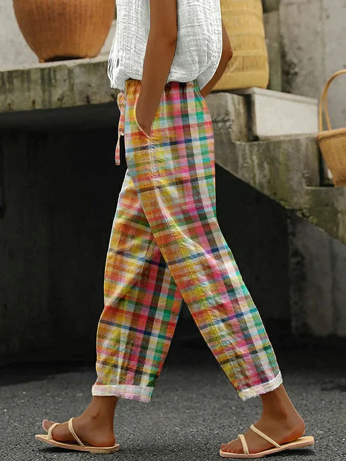 Female model wearing checkered pants against a plain background.