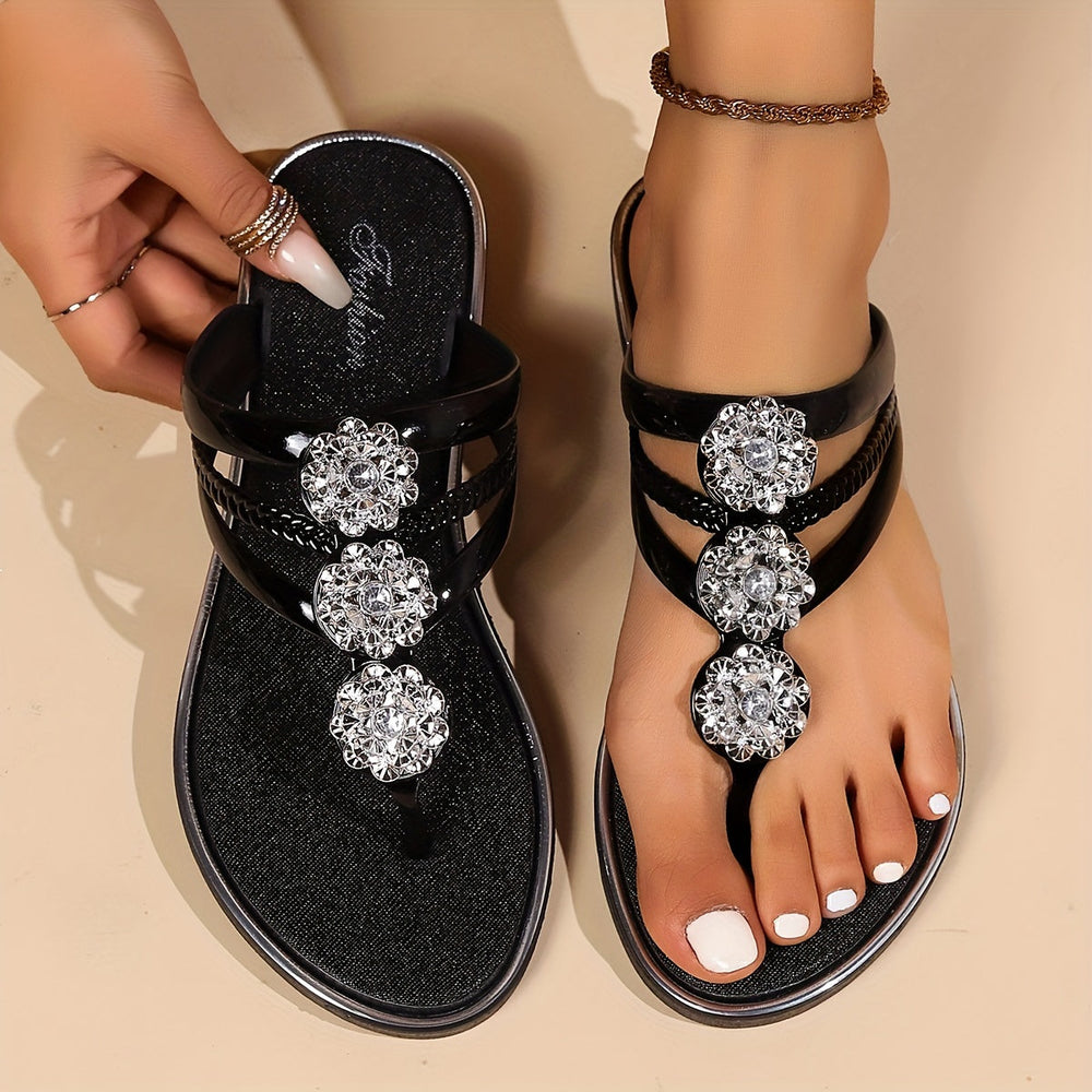 Female feet in elegant glam sandals with crystal strap details on a clean background.