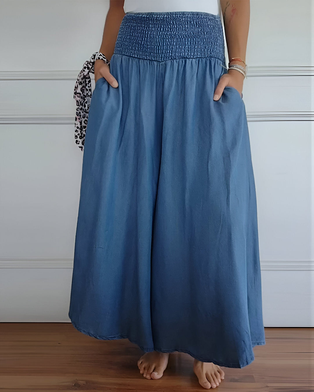 Women’s elastic waist pants on a plain background.