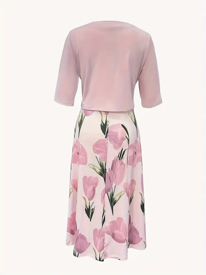 Female model showcasing a long floral dress and matching outer layer, back view