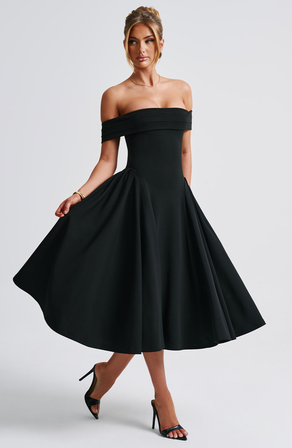 Model wearing a chic A-line midi dress for formal evening occasions.