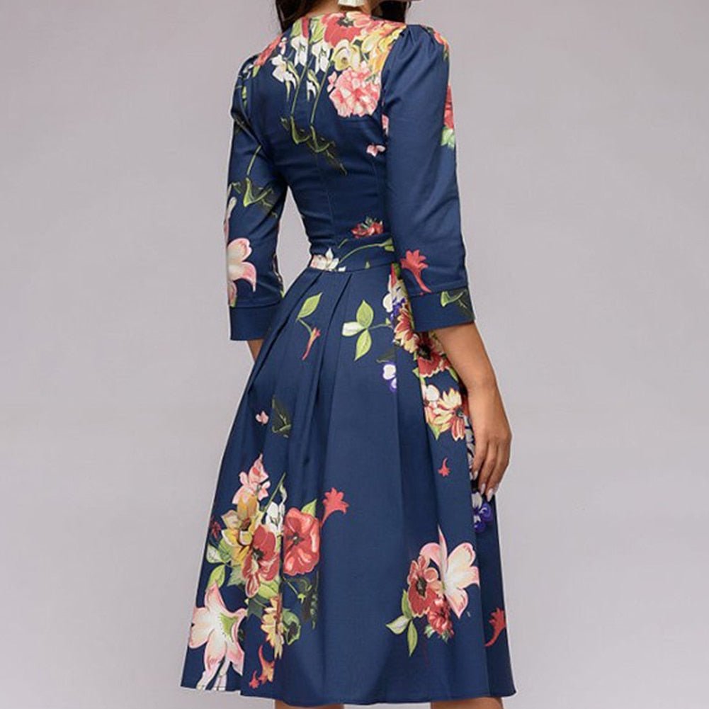 Woman showcasing a 3/4 sleeve A-line floral dress with a fitted waist, back view