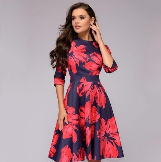 Woman posing in a fitted waist floral dress with 3/4 sleeves.