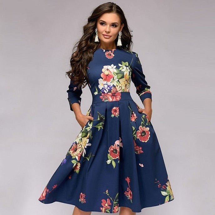 Model wearing a women’s floral knee-length dress on a plain background.