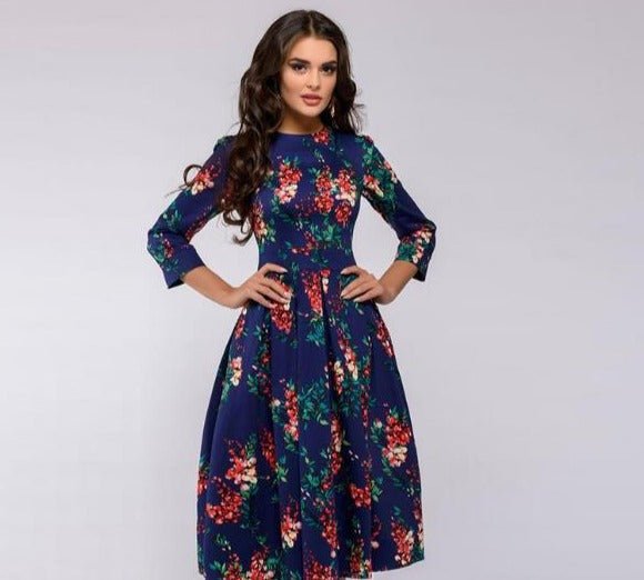 Female showcasing a casual floral A-line dress against a clean background.