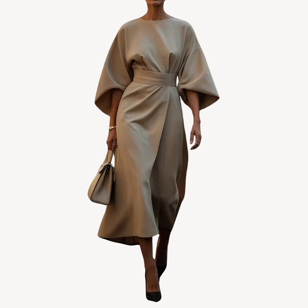Female wearing a belted midi dress with wide sleeves against a plain background.