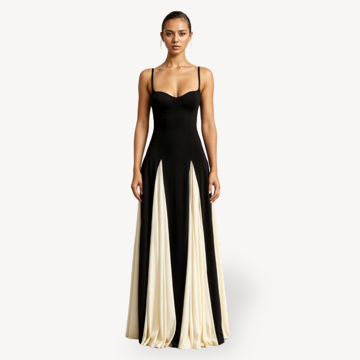 Woman wearing satin maxi dress with spaghetti straps on a plain background.