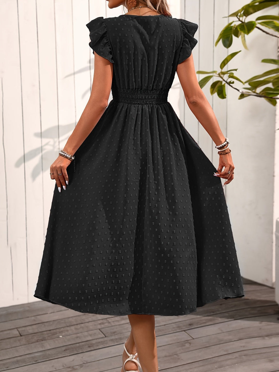 Female in a comfortable V-neck midi dress with ruffle sleeves and casual elegance, back view