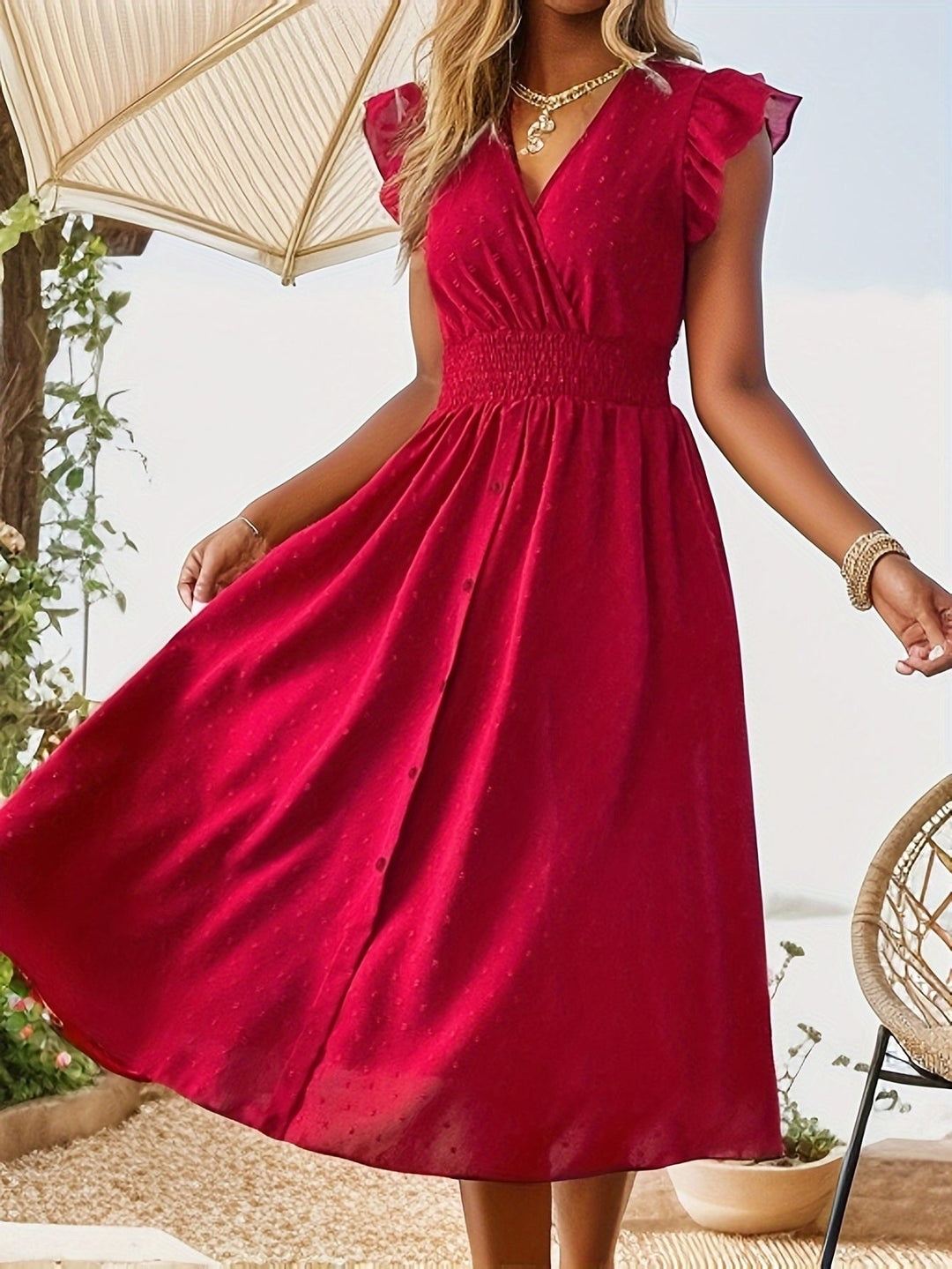Woman wearing a casual midi dress with V-neckline, button front, and nature background.