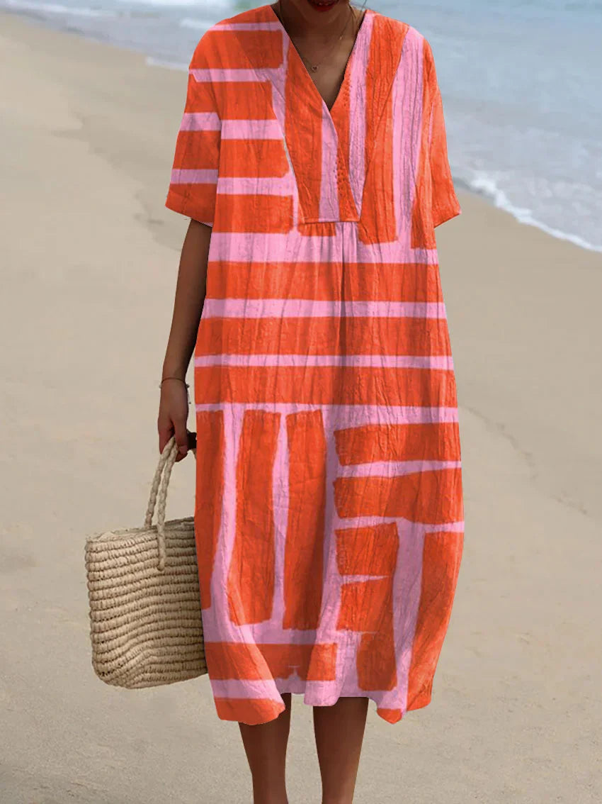 Model in a casual dress with airy movement against a plain background.