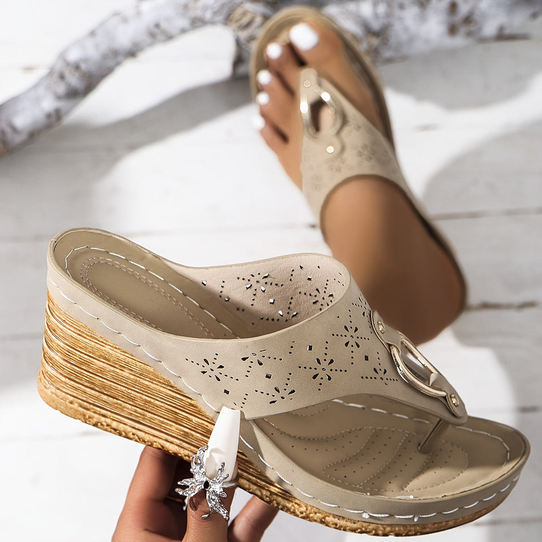 Feminine sandals on a plain background featuring a cushioned insole and polished look.