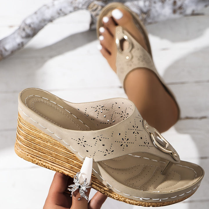 Feminine sandals on a plain background featuring a cushioned insole and polished look.