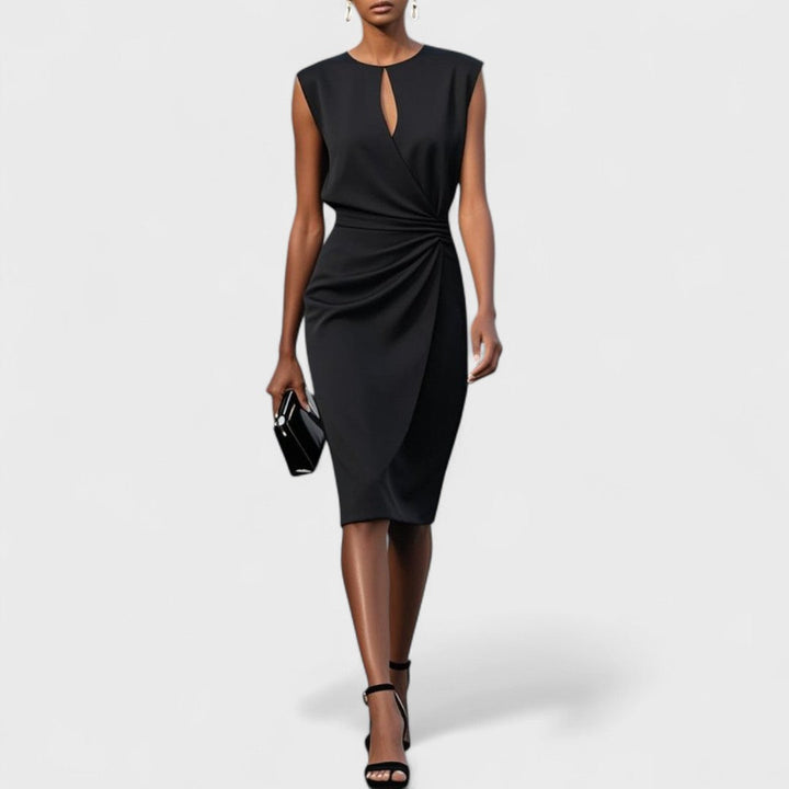 Feminine flowing dress with model on a clean background.