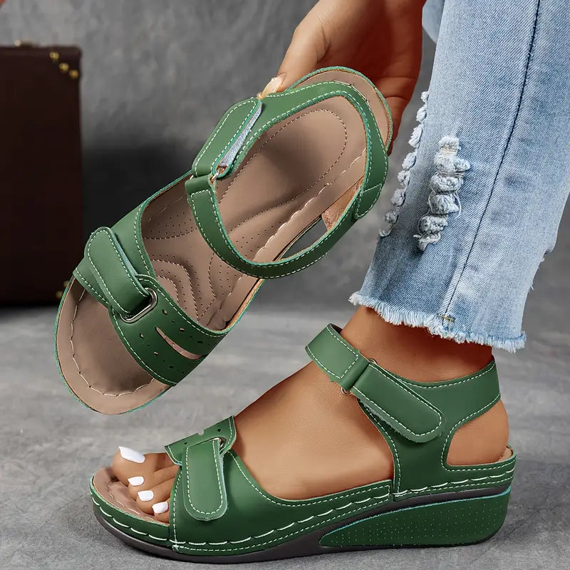Close-up of foot in comfortable women’s sandal on a clean background.