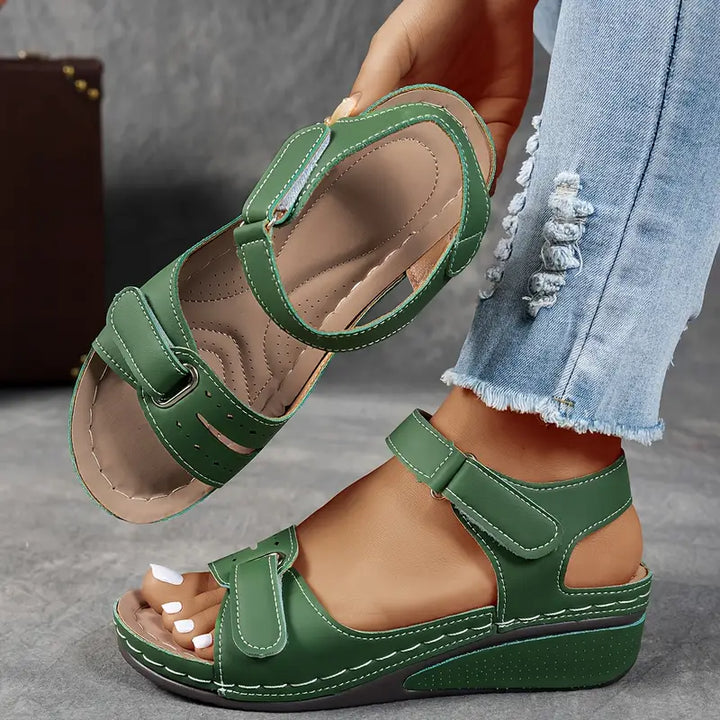 Close-up of foot in comfortable women’s sandal on a clean background.