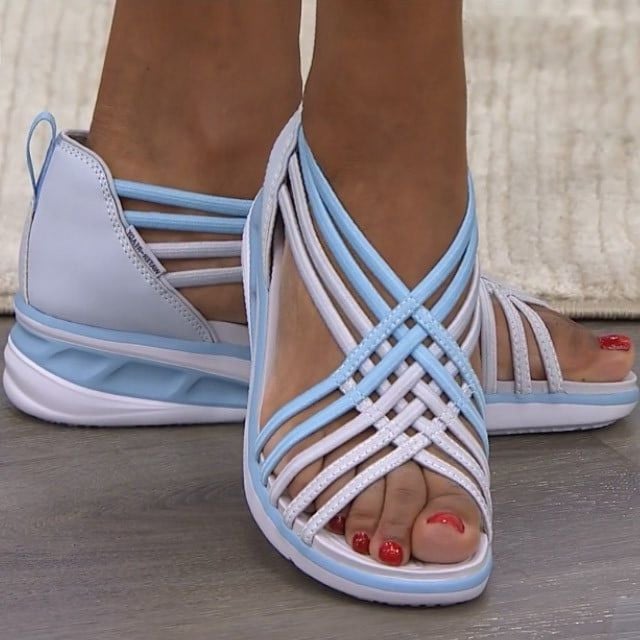 Supportive walking sandals on a plain background with cushioned sole design.