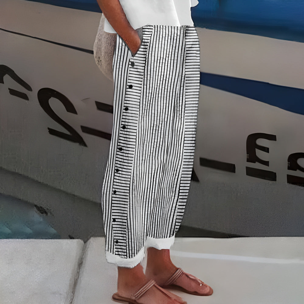 Woman modeling relaxed fit trousers with side pockets against a clean background.
