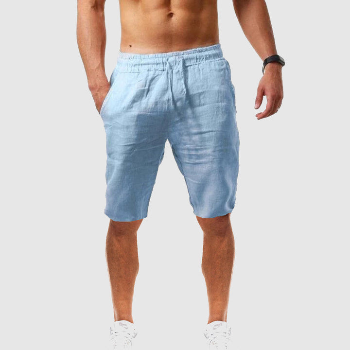 
Woman modeling relaxed summer shorts with pockets on a plain background.