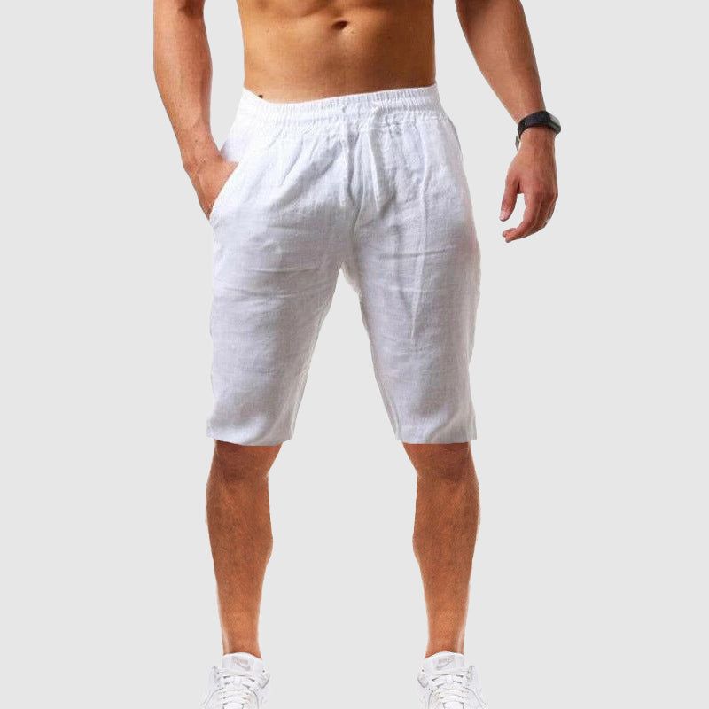 Woman wearing easy pull-on shorts for warm weather on a plain background.