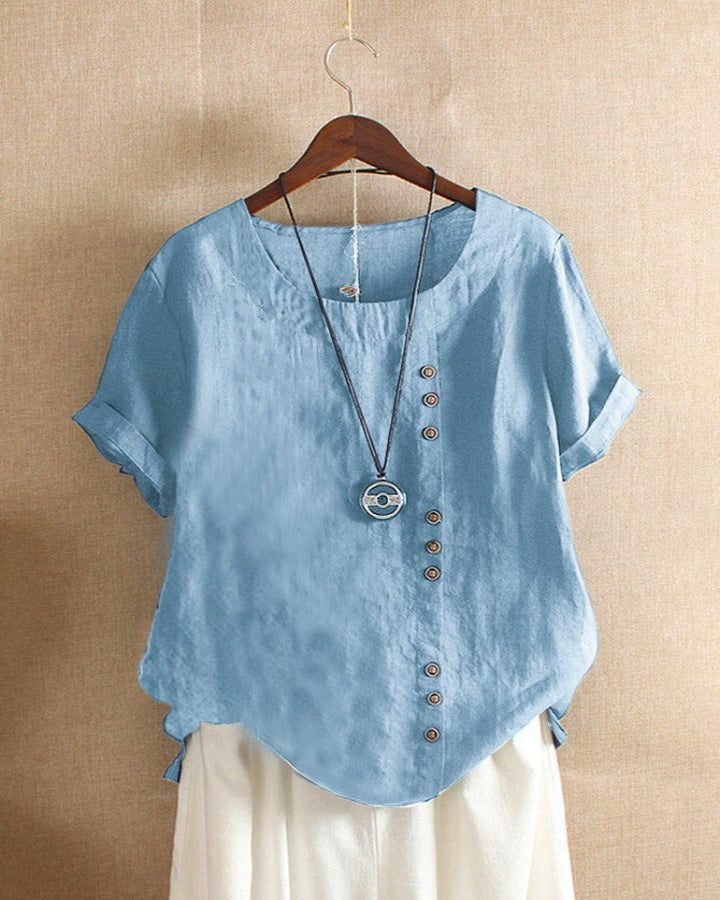Casual chic long sleeve blouse displayed against plain background.