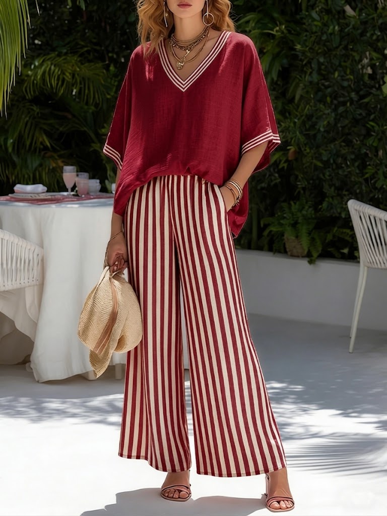 Female model wearing a striped casual two-piece outfit with a V-neckline on a plain background.