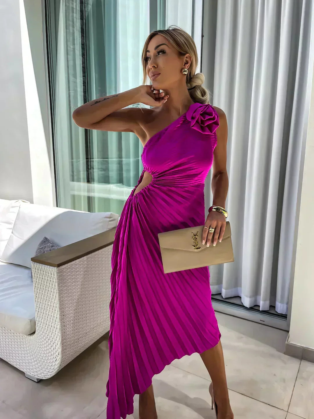 Woman displaying a feminine floral dress with soft seasonal styling.