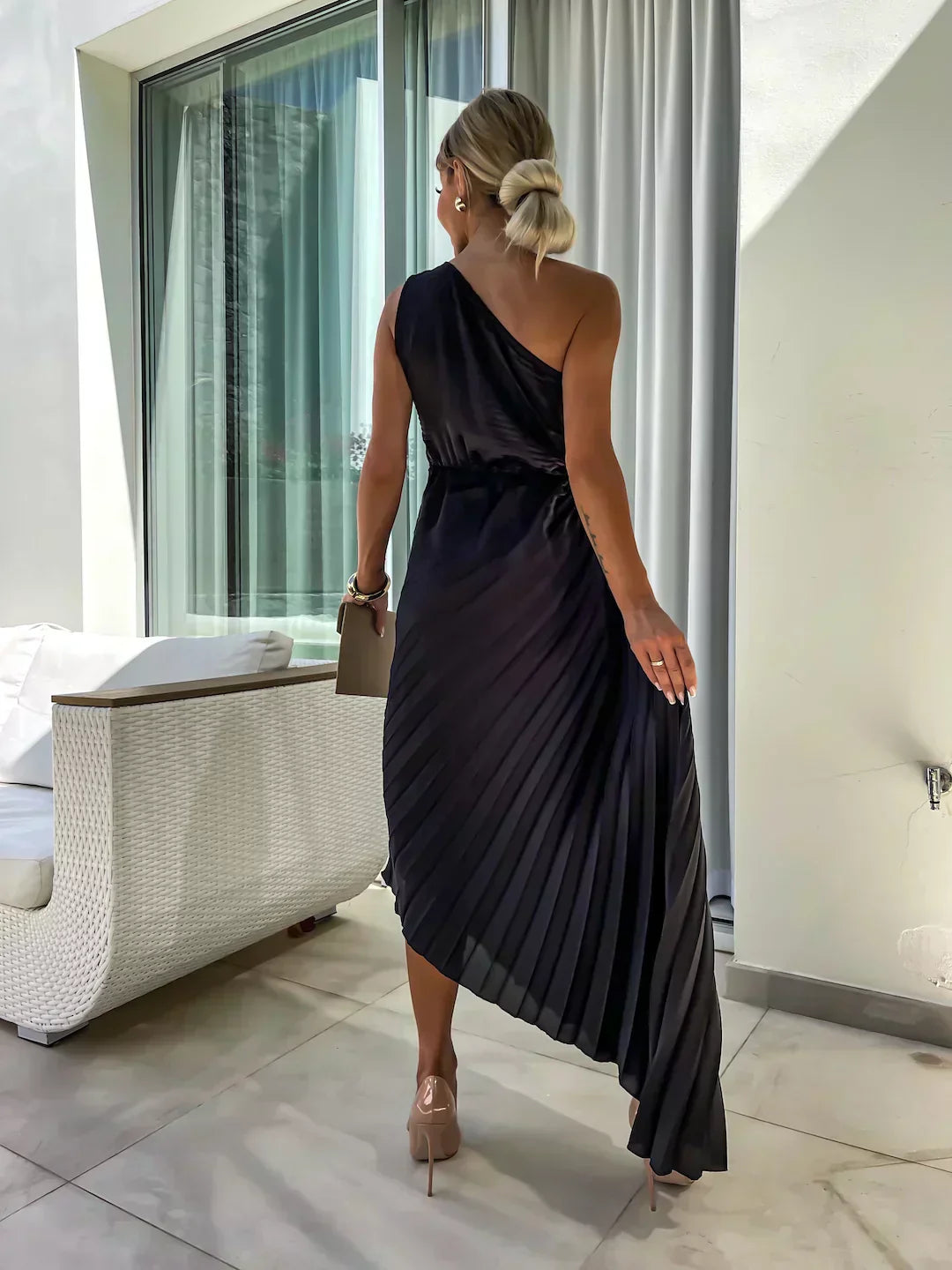 Woman wearing a flattering floral dress with an airy and graceful silhouette.
