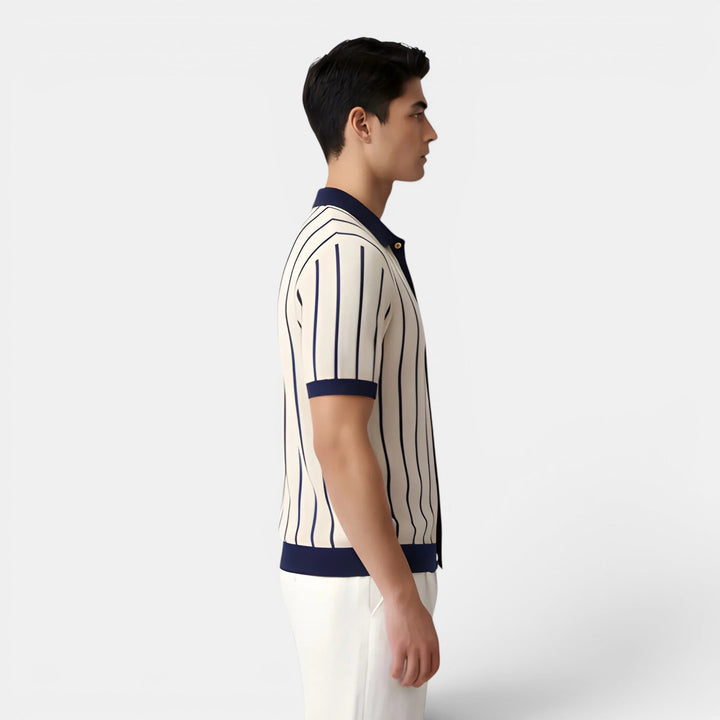  Man wearing a classic striped polo shirt with a relaxed fit on a plain background.