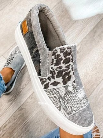 Women’s everyday walking shoes shown on female feet with plain background.