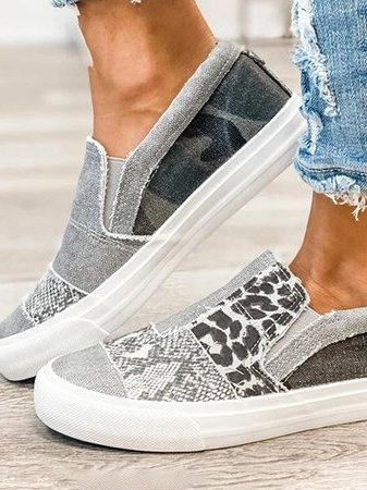Casual women’s slip-on footwear displayed by a female model on plain background.