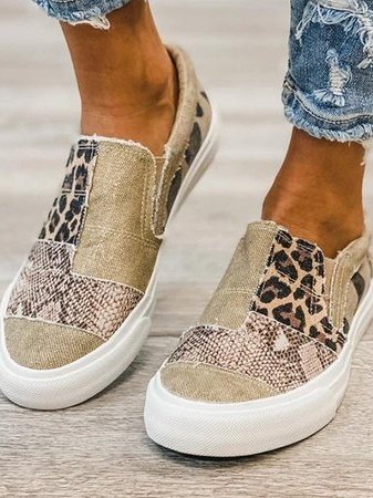 Female feet wearing cushioned everyday slip-ons on a clean plain background.